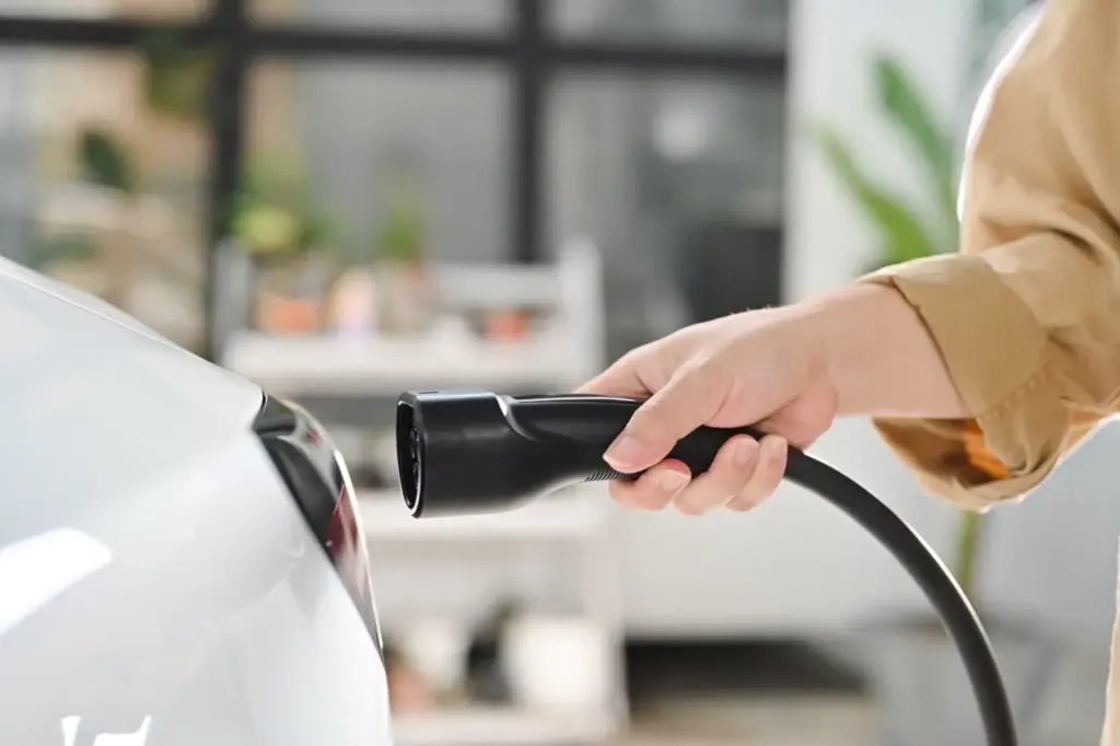 Hand charging electric vehicle indoors during the 2026 03 13 01 54 23 utc groot